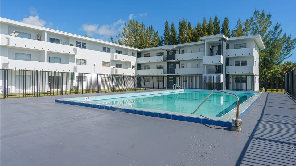 Swimming pool and renovated exterior at Lakeshore Presidential Apartments