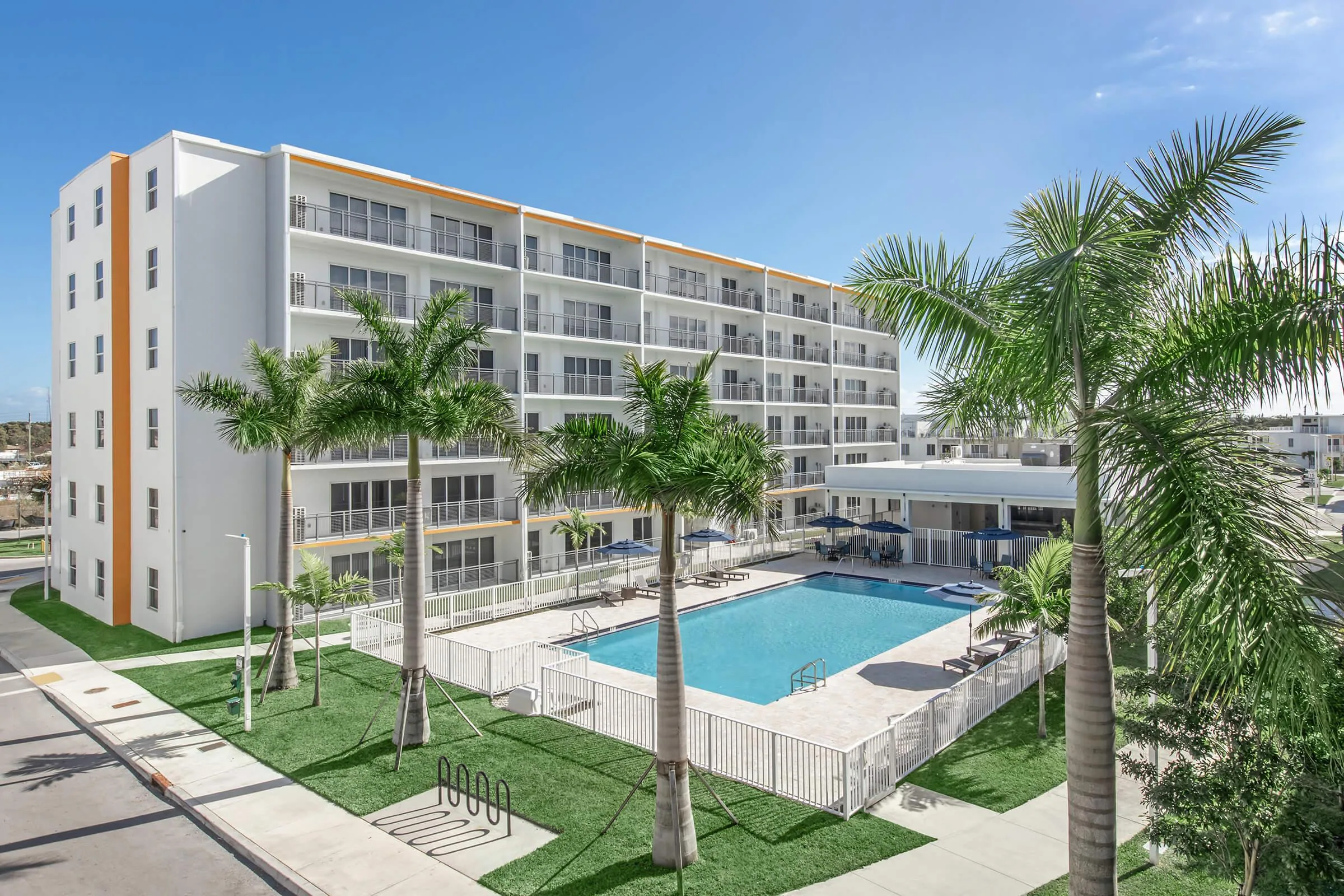 Modern Towers building overlooking the pool and landscaped courtyard.